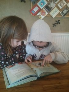 Kids looking at Bible