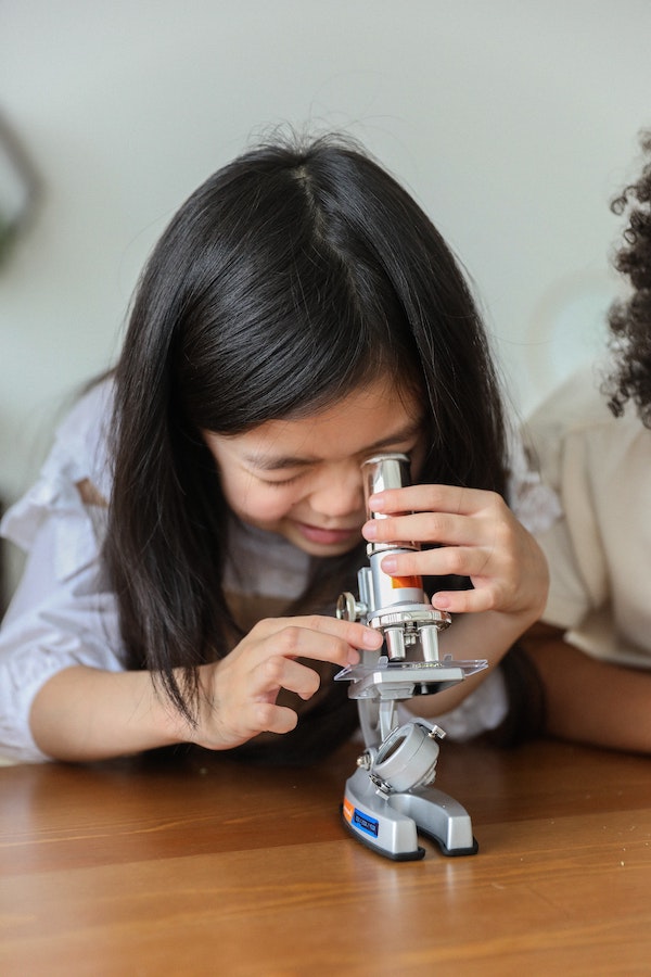 Girl looking in a microscope